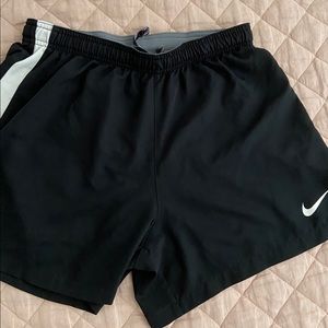 Black nike running shorts white strip on sides
